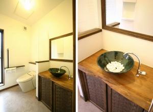 広々としたトイレ空間。ご主人こだわりの笠間焼きの手洗いボールを使用した、造作の洗面台。